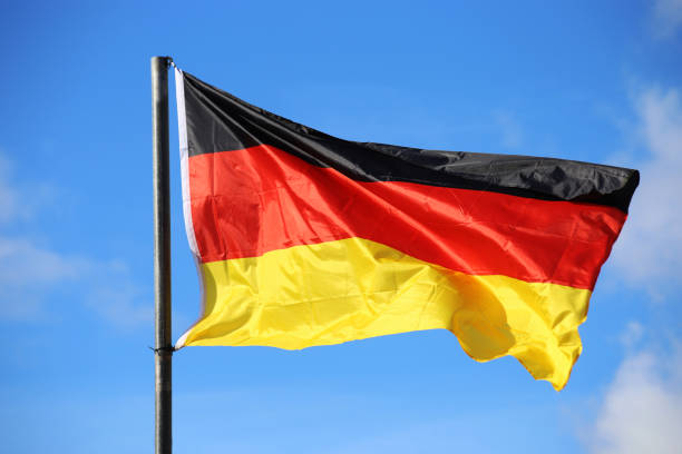 istock German flag in front of a blue sky 1283814705