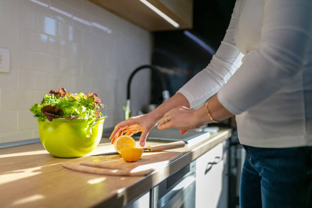 istock Taking halved lemon to season lettuce in bowl 1283815038