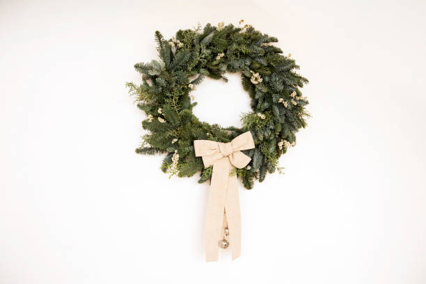 istock Christmas wreath on white wall 1283815235