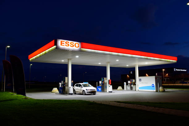 esso self service retail gasoline station at night - gazoline imagens e fotografias de stock