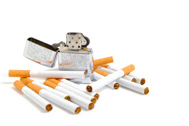 istock Petrol lighter and cigarettes on a white background. 1283815817