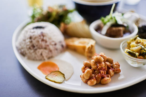 Delicious chicken with rice, vegetables, and sauces arranged on a tray.