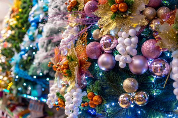 A lineup of colorful vinyl Christmas trees decorated with ornaments, balls, and LED lights. Displayed at a local shop or department store for sale. A lineup of colorful vinyl Christmas trees decorated with ornaments, balls, and LED lights. Displayed at a local shop or department store for sale. divisoria market stock pictures, royalty-free photos & images