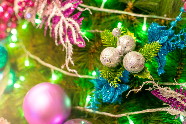 A vinyl Christmas tree decorated with blue, silver and violet ornaments and balls, and green LED lights. Displayed at a local shop or department store for sale. A vinyl Christmas tree decorated with blue, silver and violet ornaments and balls, and green LED lights. Displayed at a local shop or department store for sale. divisoria market stock pictures, royalty-free photos & images