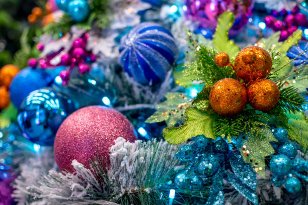 Closeup of a Snow Vinyl Chirstmas Tree decorated with colorful balls and ornaments, and blue LED lights. Displayed at a local shop or department store for sale. Closeup of a Snow Vinyl Chirstmas Tree decorated with colorful balls and ornaments, and blue LED lights. Displayed at a local shop or department store for sale. divisoria market stock pictures, royalty-free photos & images