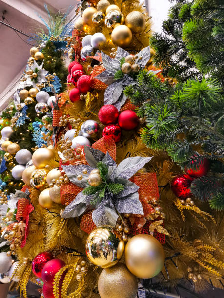 A row of fully decorated Christmas tree on display at a local shop or department store. A row of fully decorated Christmas tree on display at a local shop or department store. divisoria market stock pictures, royalty-free photos & images