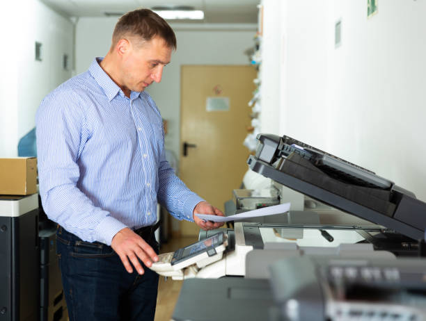 istock Worker is printing a file, document in the office room 1283817262