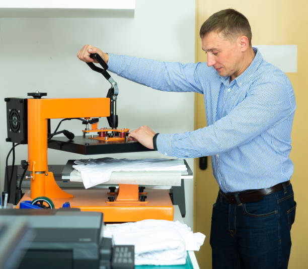 istock Man printing t-shirt in a workshop 1283817267
