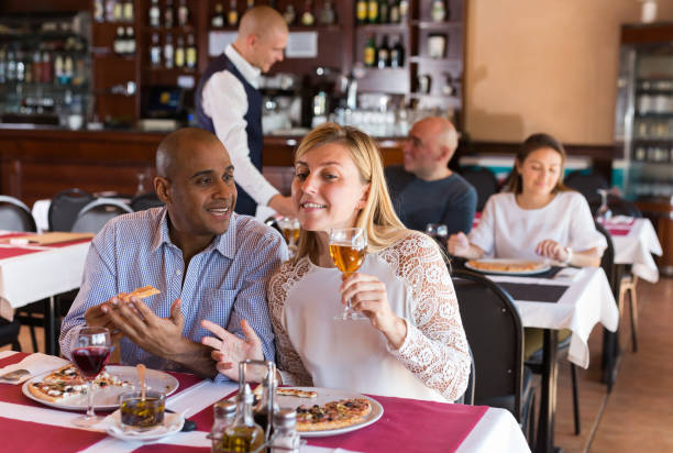 istock Happy couple enjoying pizza with wine in restaurant 1283818317