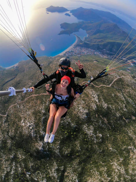 istock Paragliding pilot with customer. Tandem paragliding. 1283819282