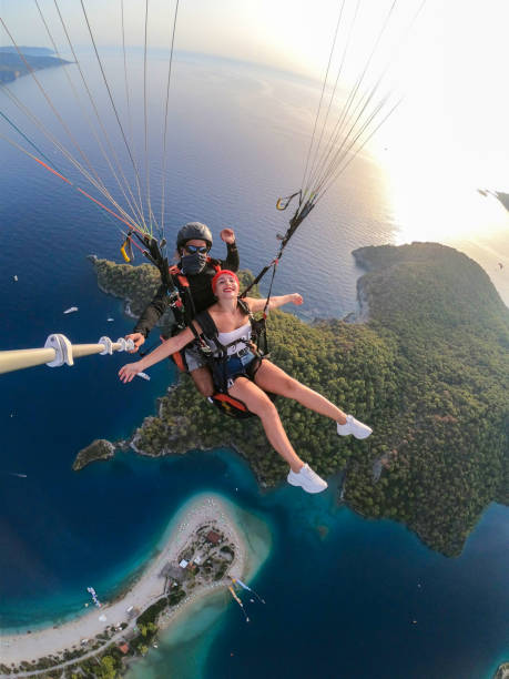istock Paragliding pilot with customer. Tandem paragliding. 1283819414