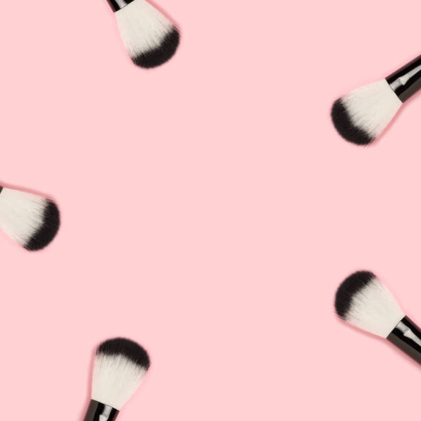 istock Border frame made of makeup brushes on a pink background. 1283819675