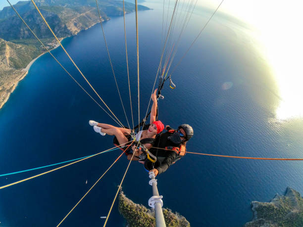 istock Paragliding pilot with customer. Tandem paragliding. 1283819677