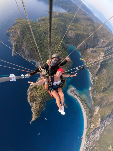 istock Paragliding pilot with customer. Tandem paragliding. 1283819697