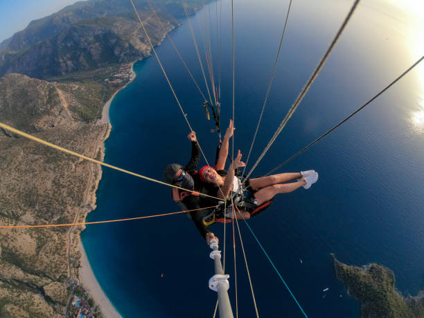 istock Paragliding pilot with customer. Tandem paragliding. 1283819727