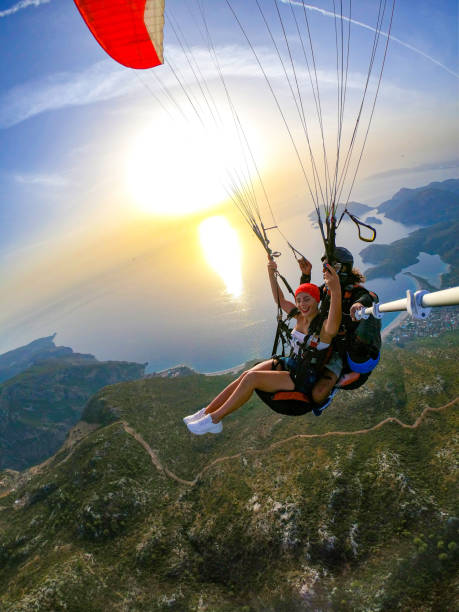 istock Paragliding pilot with customer. Tandem paragliding. 1283819868