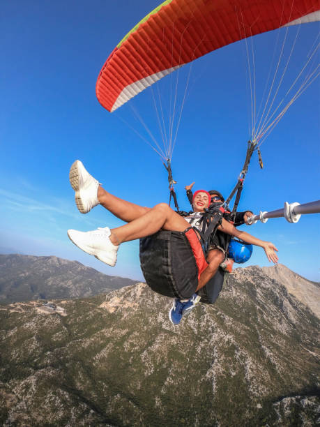 istock Paragliding pilot with customer. Tandem paragliding. 1283820744