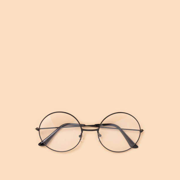 istock Round vintage eyeglasses on a beige background. 1283820780