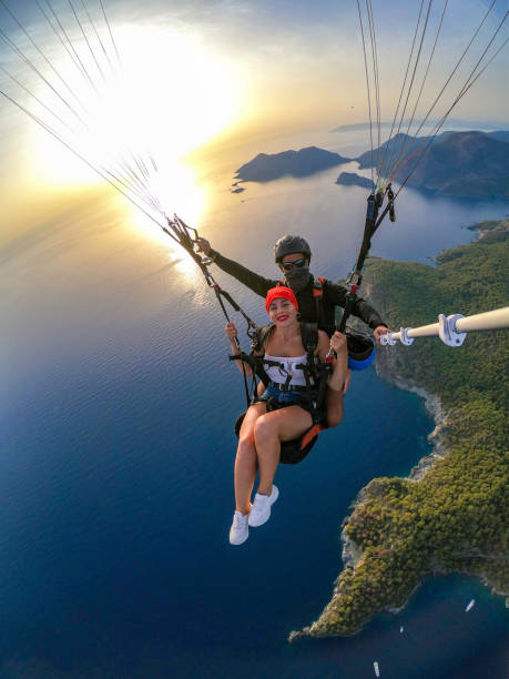 istock Paragliding pilot with customer. Tandem paragliding. 1283820809
