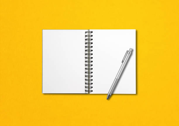 istock Blank open spiral notebook and pen isolated on yellow 1283821083