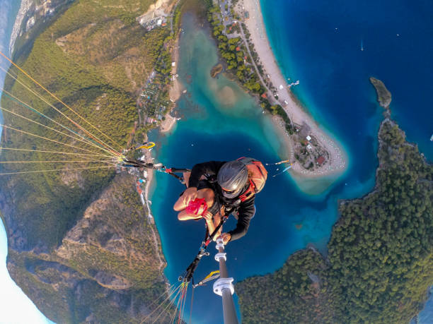 istock Paragliding pilot with customer. Tandem paragliding. 1283821138