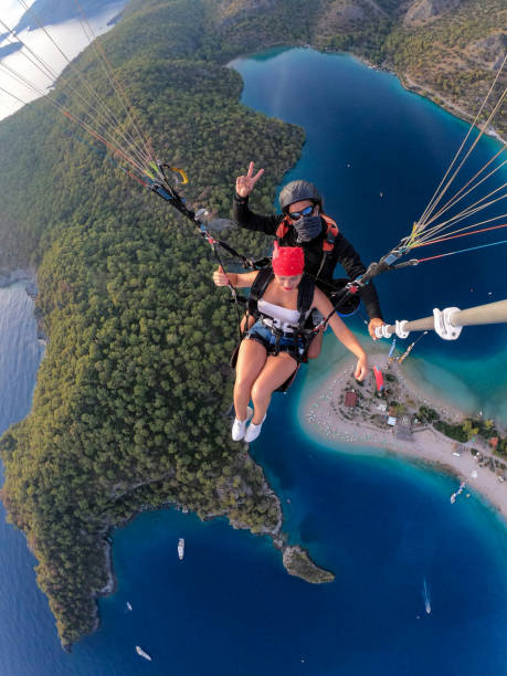 istock Paragliding pilot with customer. Tandem paragliding. 1283821231