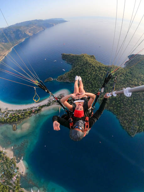 istock Paragliding pilot with customer. Tandem paragliding. 1283821395
