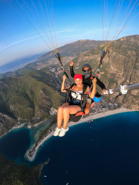 istock Paragliding pilot with customer. Tandem paragliding. 1283821641