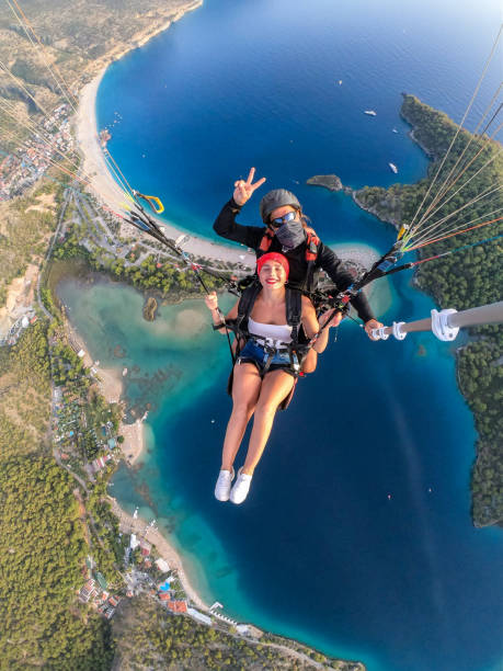 istock Paragliding pilot with customer. Tandem paragliding. 1283822617