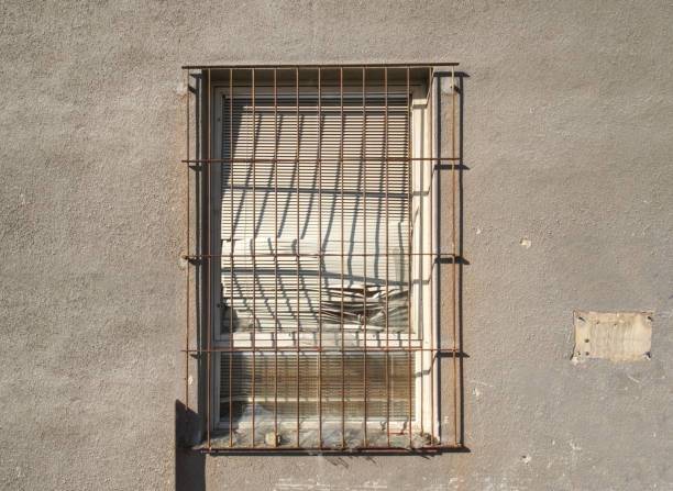 istock Old Brick-Lined Window In Old Abandoned House. Old Architecture. Old Windows With Rusty Bars 1283822796