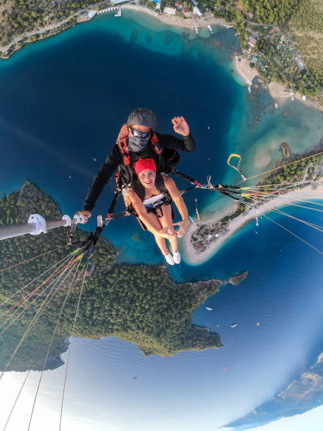 istock Paragliding pilot with customer. Tandem paragliding. 1283822957