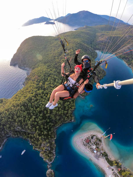 istock Paragliding pilot with customer. Tandem paragliding. 1283823020