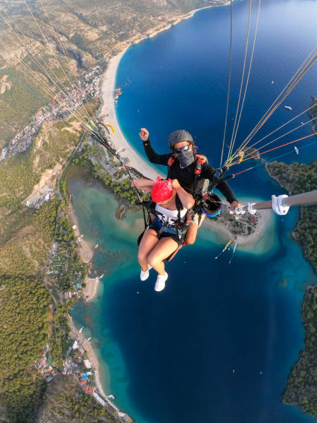 istock Paragliding pilot with customer. Tandem paragliding. 1283823238