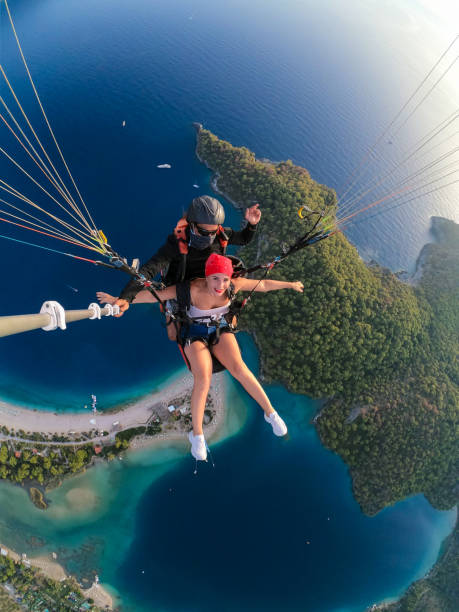 istock Paragliding pilot with customer. Tandem paragliding. 1283823312
