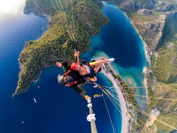 istock Paragliding pilot with customer. Tandem paragliding. 1283824267