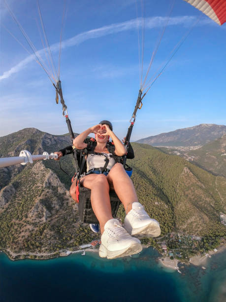 istock Paragliding pilot with customer. Tandem paragliding. 1283824312