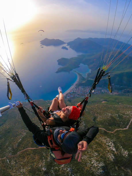 istock Paragliding pilot with customer. Tandem paragliding. 1283824328