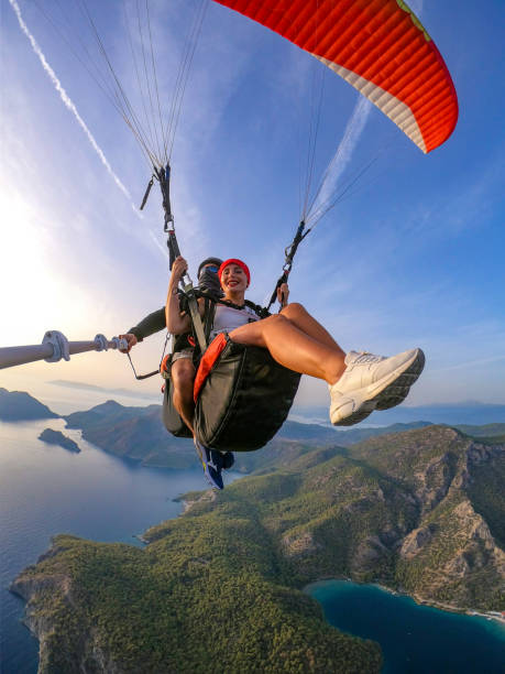 Paragliding pilot with customer. Tandem paragliding. Paragliding pilot with customer. Tandem paragliding. paraglider stock pictures, royalty-free photos & images