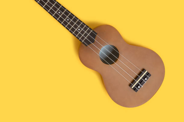 istock Flat lay of ukulele on a bright yellow background. 1283826645