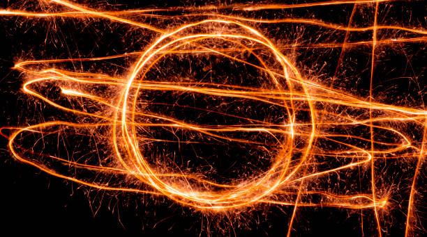 istock Light wave trail path, vibrant neon gold color in abstract swirls on a black background 1283826878