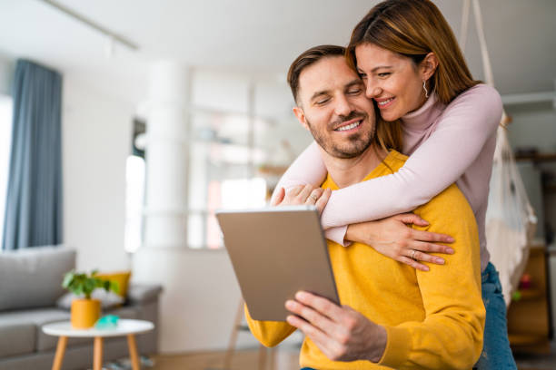 istock Happy couple spending time with tablet at home 1283826969