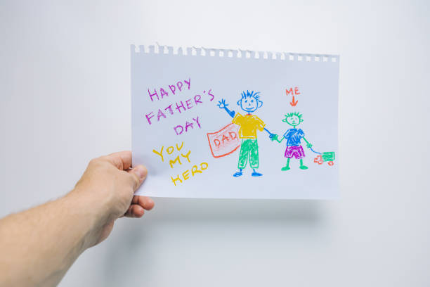 istock kid drown picture in men hands. happy father day 1283828632