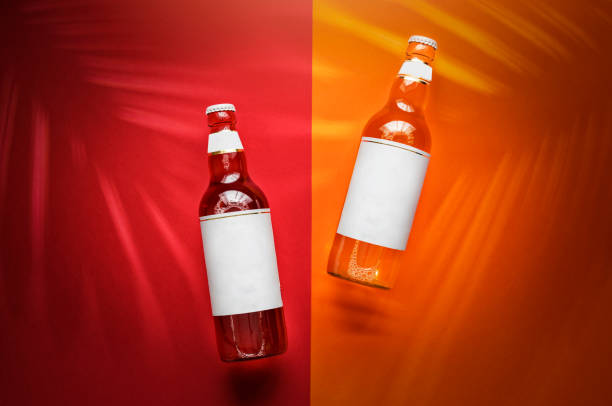 Glass bottles with colourful drink inside on a colourful background