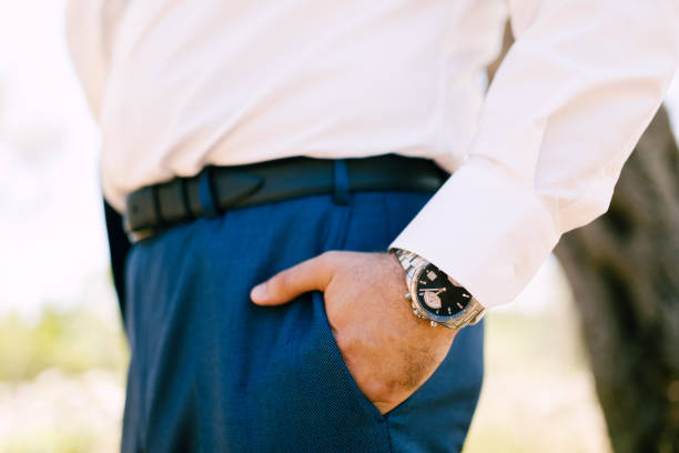 istock the groom holds his hand in his pants pocket 1283830866