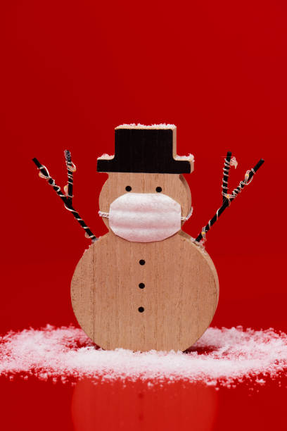 istock snowman wearing a face mask 1283833973