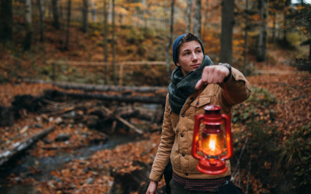 istock A man walking in the woods with an old lantern in his hand 1283834174