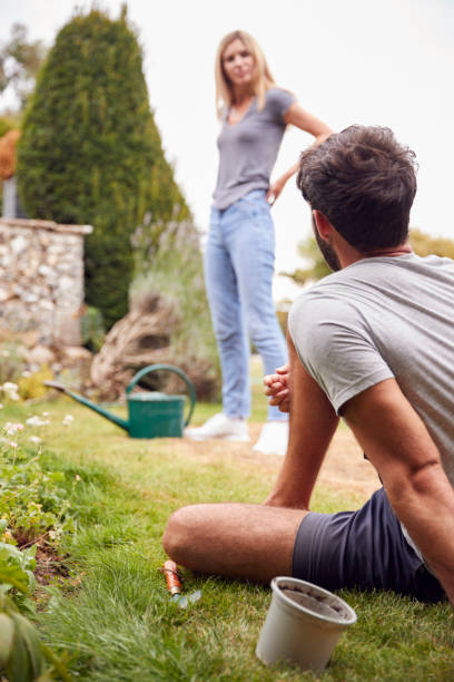 istock Couple Working Outdoors In Garden At Home Digging And Planting 1283835325