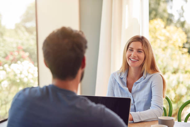 istock Couple With Laptop Sitting At Table Working From Home Together 1283836407