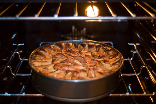 Apple pie baking in oven. Traditional French apple pie in the oven. Apple pie baking in oven. Traditional French apple pie in the oven. apple pie a la mode stock pictures, royalty-free photos & images