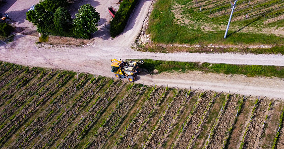 Agricultural tractor beside vineyard acre, Tuscany province, Italian countryside. Chianti area near Pontassieve.